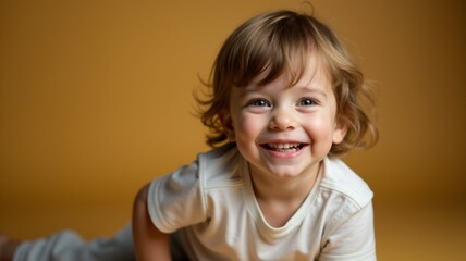 Wall Mural - A young child is smiling and looking at the camera