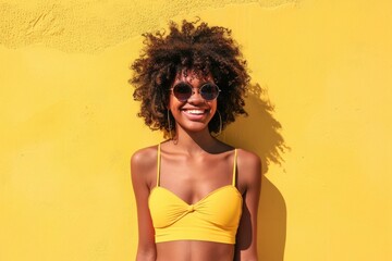 Wall Mural - A woman poses in a bright yellow bikini on a sunny day