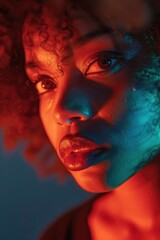 Wall Mural - A close-up shot of a woman's face with vibrant red and blue lighting