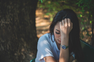 Frustrated Upset woman sitting green park loneliness. Heartbroken Women worried make mistake negative emotion panic hurt feeling depression. Women regret sad cry loss nostalgia thinking pain mental