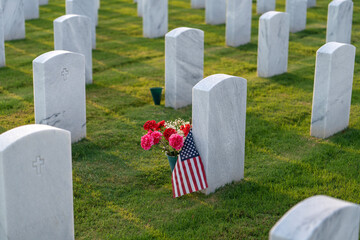 American army Sarasota National Cemetery with rows of white tombstones with USA flags and flowers. Memorial Day concept