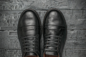 Top View of Black Formal Leather Shoes on Wooden Floor Background