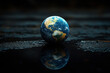 © Phichitpon - The Earth Globe sits on the ground in the middle .ecological environment concept