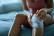 © Emanuel - Woman applying an ice pack to her knee to reduce pain and swelling