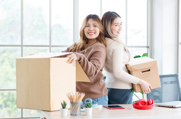 Wall Mural - Portrait two roommates happy young Asian female moving packing things in box into new apartment, carry cardboard boxes, Concept teenage or friends, Real estate property buying, relocation, new home