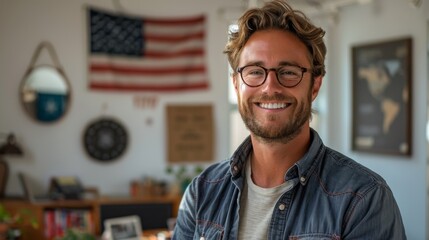 Wall Mural - A photograph of a 25-year-old american man, dressed cool and fashion. he has a warm demeanor, smiling happily. he is at a white and bright american office. There is an USA flag behind him