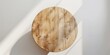 © Usman - An empty white wooden round table is placed on a white wall background. The layout should be clean and simple.