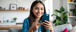 © Shadaw - Happy hispanic teen girl holding cell phone using smartphone device at home