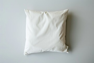 Poster - A white pillow sitting on a gray wall, perfect for interior design and decoration inspiration