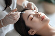 © Alexey - Beautiful asian woman receives an injection in the forehead. Botox for Forehead Lines and Wrinkles. Skin Tightening Treatment. Plasma lift procedure.
