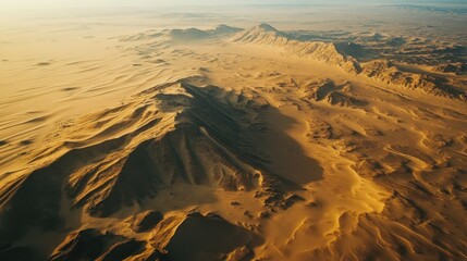 Wall Mural - Aerial View of Sand Dunes and Mountainous Terrain in a Desert Landscape