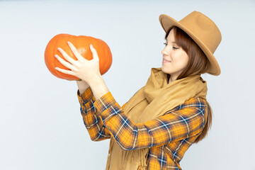 Sticker - A large, juicy pumpkin in a woman's hands, close-up