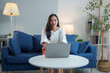© crizzystudio - Modern working lifestyle Asian businesswoman sitting on sofa at home office working on laptop online using internet to get information, chat, to shop happily online.
