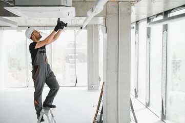 Wall Mural - technician cleans air conditioner system in a modern apartment