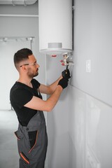 Poster - Professional plumber servicing a boiler