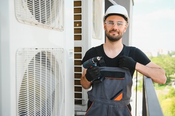 Wall Mural - Technician man install new air conditioner, Repairman service for repair and maintenance of air conditioners