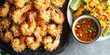 © jambulart - Coconut shrimp with mango salad and dipping sauce.