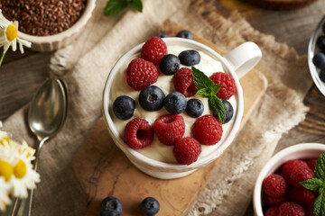 Wall Mural - A bowl of cottage cheese with flax seed oil with fresh blueberries and raspberries