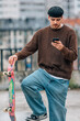 © carballo - young man on the street with mobile phone and skateboard