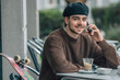 © carballo - young urban man on the cafe terrace with mobile phone and skateboard