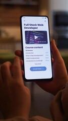 Learning to code online. Checking full stack web development online course using app for mobile phone. Fictional Interface, vertical video.