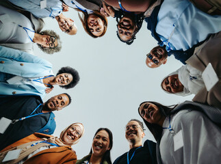 Wall Mural - company staff team smiling together in a huddle