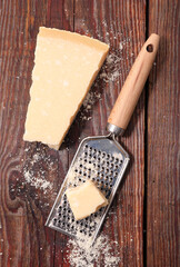 piece of parmesan cheese on wood background