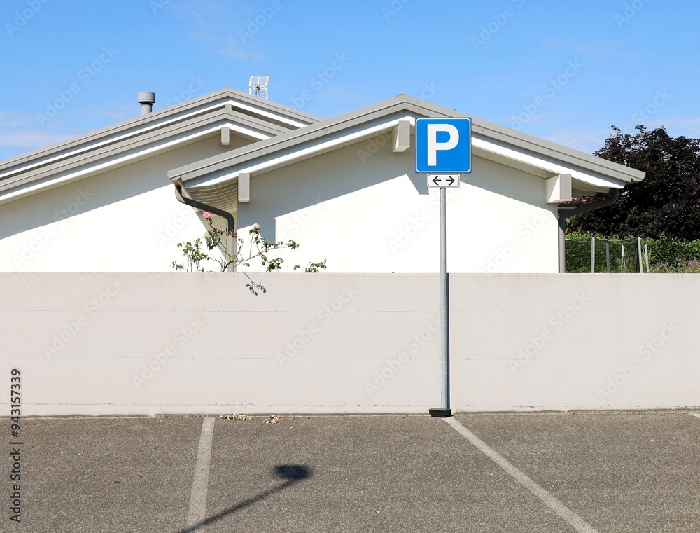Parking sign in front of two white modern houses with gray plaster ...