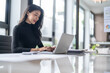 © Charlie's - Beautiful confident asian business woman working with laptop Hands typing  keyboard. Professional investor working new start up project. business planning in office. Technology business