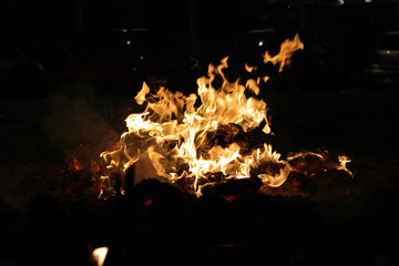 Chinese hungry ghost festival prayer offering joss paper money candle burning fire flame smoke