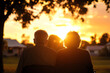 © PoodPhoto - Elderly couple sitting together watching a beautiful sunset, capturing a moment of love, peace, and tranquility in a serene outdoor setting.
