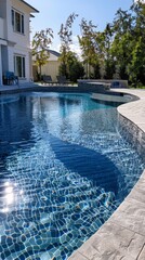 Poster - A pool with a blue tile design and a white house in the background