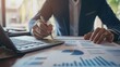 © Harjo - businessman analysis of business financial reports. Management of company data, metrics and marketing KPIs, financial status in beautiful graphs and reporting daily or monthly sales information simult