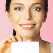 © vgstudio - Closeup portrait of smiling woman showing white blank mockup empty businesscard plastic credit card, with copy space, isolated pink background. Brunette female model at studio image.