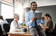 © peopleimages.com - Businessman, thinking and smile on tablet in office for corporate research, company website and communication. Professional, coworkers or digital tech at work for email feedback or online information
