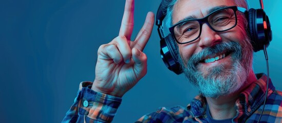 Poster - A friendly smiling middle aged man holding up three fingers embodies the concept of headphones and smartphone in a pleasant copy space image