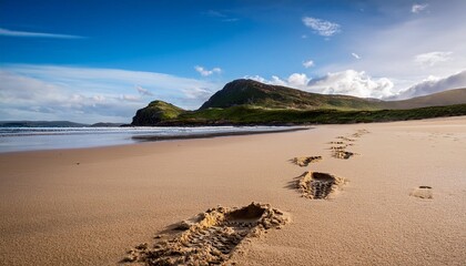 Sticker - footprints of hiking boots on the sand of a remote beach in scot