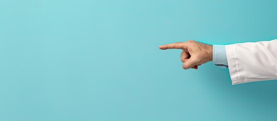 Sticker - Close up image of a doctor pointing at an object on a light blue background with ample space for text