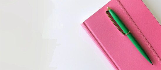 Aufkleber - Minimalist top down view of a delicate pink notebook with a vibrant green pen resting on a blank white surface suitable for school or office themed backgrounds featuring a flat lay composition with a