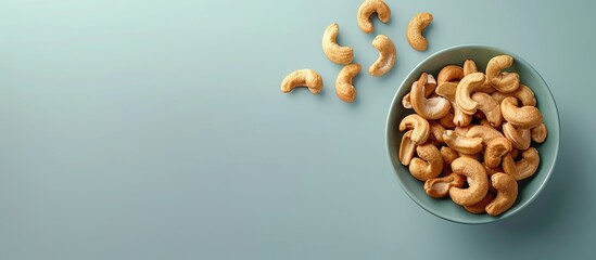 Aufkleber - Close up view of freshly roasted cashews on a plain background with ample copy space image