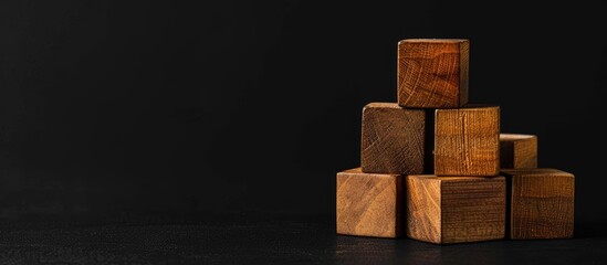 Poster - Wooden blocks with a black background displaying a career advancement message symbolizing progress Ample copy space image provided