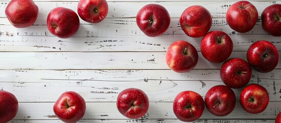 Aufkleber - Red apples arranged on a white wooden surface in a flat lay style offering ample copy space for inserting text in the image