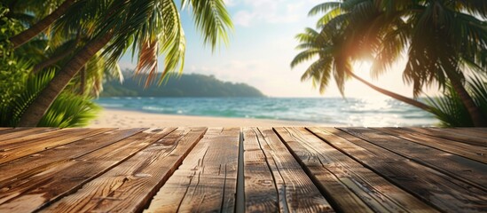 Poster - A wooden table set against a blurred summer beach with palm trees creating a scenic backdrop for showcasing summer products with copy space image