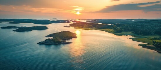 Canvas Print - Aerial drone shot of a serene lake coast at sunset with islands and a clear view ahead ideal for use as a copy space image