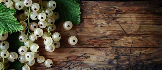 Sticker - Top view of white currant berries and green leaf arranged on a wooden table with a designated area for text in the image. Creative banner. Copyspace image