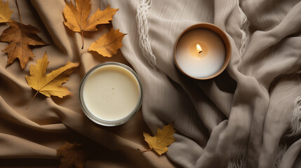 Wall Mural - Flat lay with fabric draping, fallen leaves and a beautiful candle on a white tabletop