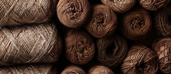 Poster - Knitting pattern rolls with a blend of brown hues are displayed in a copy space image