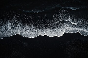 Canvas Print - White waves on a black beach