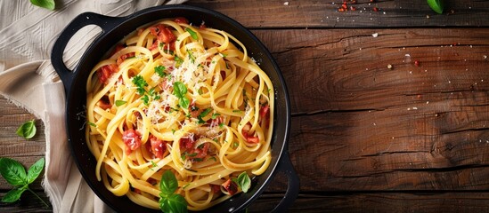 Aufkleber - Wooden background featuring a scrumptious pasta carbonara in a frying pan with ample space for further imagery