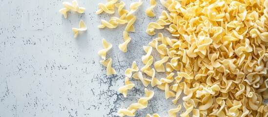 Poster - Top view of raw dried spaetzle egg noodle on a gray background with copy space image